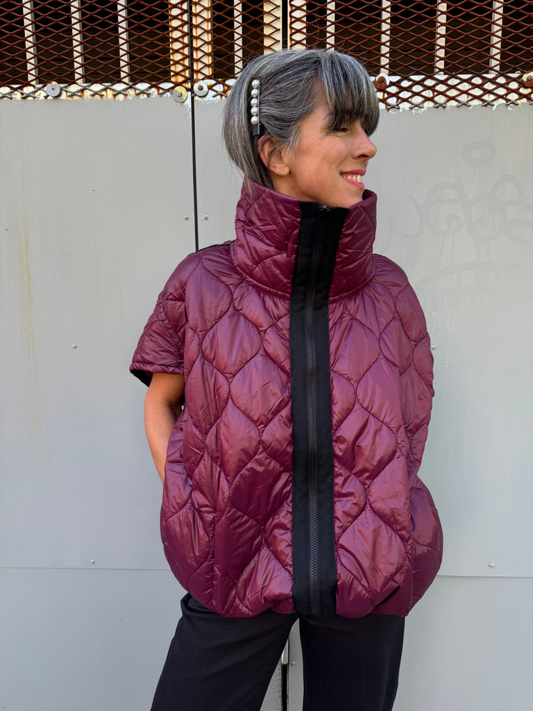 Burgundy quilted vest with a black zipper