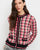 A pink and black plaid button up cardigan