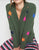Green cardigan with colorful star patterns 