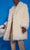 Person wearing a fluffy white coat against a blue background