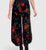 Black velvet pants with red and green floral pattern 