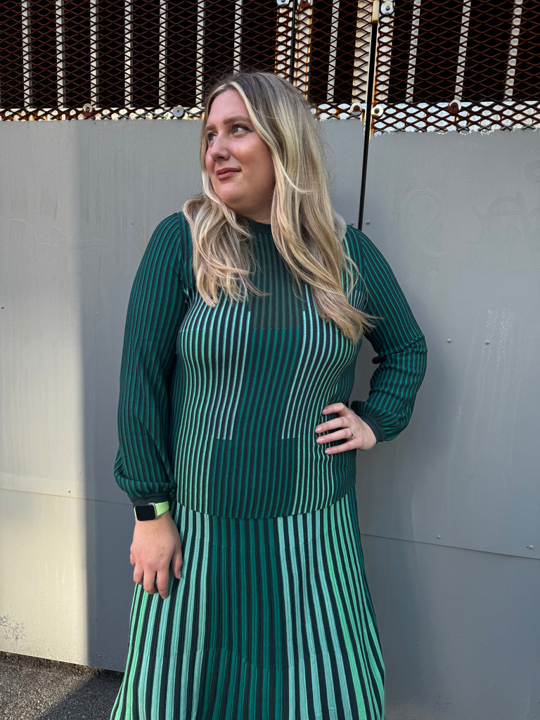 Woman wearing a green and black striped top