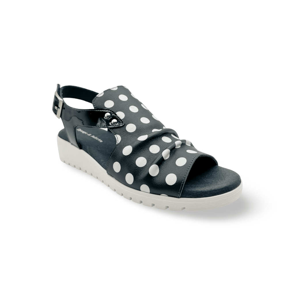 Navy sandal with white polka dots, adjustable velcro closure 