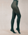 Dark green tights worn by a person on a beige background