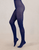 Navy blue tights worn by a person on a beige background